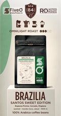 A bag of Five O' Coffee Brazilia Bossa Nova coffee beans displayed on a white pedestal. The packaging features a black resealable pouch with a white and green label, set against a white background with green and brown graphic accents and text detailing the roast and origin.
